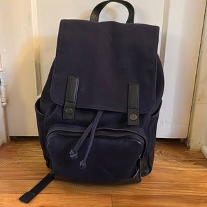 Everlane backpack with laptop sleeve, water bottle holder and drawstring top.